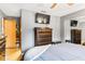 Main bedroom featuring a dresser, wall mounted television, and ample closet space at 290 Birch Ave, Orange City, FL 32763