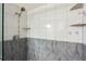 Shower showcasing white and gray tiling, with marble accents, and built-in shelves at 290 Birch Ave, Orange City, FL 32763