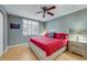 Well-lit bedroom with a large bed and plantation shutters at 3 Oceans West Blvd # 7C6, Daytona Beach, FL 32118