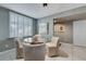 Dining area features a glass-top table with seating for four and window with plantation shutters at 3 Oceans West Blvd # 7C6, Daytona Beach, FL 32118