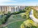 Scenic view of a golf course alongside luxurious condominium buildings at 3 Oceans West Blvd # 7C6, Daytona Beach, FL 32118