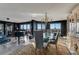 Elegant dining area with a grand piano, chandelier, and scenic views, perfect for sophisticated entertaining at 3 Oceans West Blvd # 7C6, Daytona Beach Shores, FL 32118