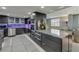 Modern kitchen featuring stainless steel appliances, granite countertops, and custom cabinetry with unique under-cabinet lighting at 3 Oceans West Blvd # 7C6, Daytona Beach Shores, FL 32118