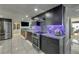 Modern kitchen with stainless steel appliances, granite countertops, and sleek dark cabinetry, seamlessly connects to dining area at 3 Oceans West Blvd # 7C6, Daytona Beach Shores, FL 32118