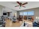 Living room with ceiling fan, desk area, and sliding glass doors to a balcony with water views at 3 Oceans West Blvd # 7C6, Daytona Beach Shores, FL 32118