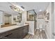 Bathroom featuring a large mirror, designer light fixture, vessel sink, and a frameless glass shower at 3000 N Atlantic Ave # 11, Daytona Beach, FL 32118