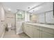 Bathroom featuring granite countertop, neutral color walls, framed mirror and a shower at 3000 N Atlantic Ave # 11, Daytona Beach, FL 32118