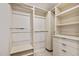 Well organized closet with shelves, rods, drawers and neutral colored walls at 3000 N Atlantic Ave # 11, Daytona Beach, FL 32118