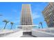 Contemporary high rise exterior with an entrance at the base and towering view with palm trees at 3000 N Atlantic Ave # 11, Daytona Beach, FL 32118