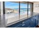 Kitchen island with cooktop and ocean view from floor to ceiling windows at 3000 N Atlantic Ave # 11, Daytona Beach, FL 32118