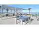 Outdoor seating area with tables, chairs, and BBQ grills offering ocean views at 3000 N Atlantic Ave # 11, Daytona Beach, FL 32118