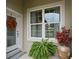 Charming front door adorned with a wreath, complemented by a window and decorative accents at 3160 Bailey Ann Dr, Ormond Beach, FL 32174