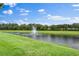 Picturesque view of the pond, lush lawn and fountain at 3160 Bailey Ann Dr, Ormond Beach, FL 32174