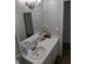 Bright bathroom with white vanity, decorative mirror and modern lighting at 3641 S Atlantic Ave # 212, Daytona Beach Shores, FL 32118