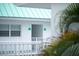 Exterior view showing a balcony with palm tree and a green roof at 3641 S Atlantic Ave # 212, Daytona Beach Shores, FL 32118