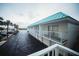 Exterior elevation featuring parking, a teal roof, and second story balconies at 3641 S Atlantic Ave # 212, Daytona Beach Shores, FL 32118