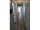 Long hallway with wood-look tile flooring, leading to a bright, open living area at 3641 S Atlantic Ave # 212, Daytona Beach Shores, FL 32118