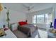 Sunlit bedroom featuring neutral walls, a ceiling fan, and a picturesque window view at 4555 S Atlantic Ave # 4708, Port Orange, FL 32127