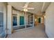 A well-lit corridor with tiled floors, teal doors, and a ceiling fan, creating a welcoming and aesthetically pleasing space at 4555 S Atlantic Ave # 4708, Port Orange, FL 32127