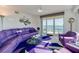 Living room features floor-to-ceiling windows, ocean view, and modern purple sofa and seating at 4555 S Atlantic Ave # 4708, Port Orange, FL 32127