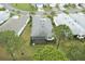 Bird's-eye view showcasing a home with a screened lanai and a manicured lawn in a quiet neighborhood at 1068 Sea Shell Ct, Daytona Beach, FL 32124