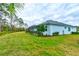 A manicured lawn surrounds the property, complete with a screened lanai for outdoor enjoyment at 1068 Sea Shell Ct, Daytona Beach, FL 32124