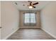 Bedroom showcasing tiled floor, ceiling fan, and a large window with coverings at 1068 Sea Shell Ct, Daytona Beach, FL 32124