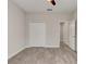 Neutral bedroom featuring ceiling fan, tiled floor, and large closet doors at 1068 Sea Shell Ct, Daytona Beach, FL 32124