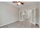 Bright bedroom featuring tiled flooring, ceiling fan, and glass french doors at 1068 Sea Shell Ct, Daytona Beach, FL 32124