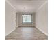 Dining room with wood-look tile flooring, neutral paint, modern chandelier, and large window at 1068 Sea Shell Ct, Daytona Beach, FL 32124