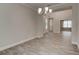 Open dining room with modern chandelier, tiled flooring, and neutral paint at 1068 Sea Shell Ct, Daytona Beach, FL 32124