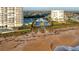 Aerial view of beachfront condominium complex featuring lush lawns and community pool at 1068 Sea Shell Ct, Daytona Beach, FL 32124