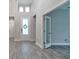 Bright foyer with tall ceilings, tiled floors and a white-framed glass front door at 1068 Sea Shell Ct, Daytona Beach, FL 32124