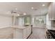 Well-lit kitchen with white cabinets, granite counters, stainless steel appliances, and wood-look tile flooring at 1068 Sea Shell Ct, Daytona Beach, FL 32124