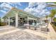 Spacious outdoor bar and lounge area with comfortable seating, tropical plants, and string lights for evening ambiance at 1068 Sea Shell Ct, Daytona Beach, FL 32124