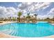 Expansive pool area with clear blue water, offering multiple seating areas and tropical landscaping for relaxation at 1068 Sea Shell Ct, Daytona Beach, FL 32124