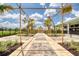 Tranquil outdoor walkway with bamboo pergola, leading to community amenities and featuring well-maintained landscaping at 1068 Sea Shell Ct, Daytona Beach, FL 32124