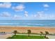 Stunning ocean view from the lush green lawn, dotted with palm trees at 1155 Ocean Shore Blvd # 507, Ormond Beach, FL 32176