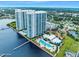 Stunning aerial view of a waterfront high-rise building with pool and beautiful landscaping at 231 Riverside Dr # 1907-1, Holly Hill, FL 32117