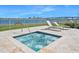 Outdoor hot tub area with lounge chairs, white fence and water view at 231 Riverside Dr # 1907-1, Holly Hill, FL 32117