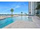 Large outdoor pool with sun loungers, city skyline view and palm trees at 231 Riverside Dr # 1907-1, Holly Hill, FL 32117