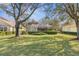 Spacious backyard with a screened-in lanai, surrounded by lush greenery at 5 Captiva At Lionspaw, Daytona Beach, FL 32124