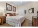 Cozy bedroom featuring neutral walls, artwork, and a comfortable queen-size bed with decorative pillows at 5 Captiva At Lionspaw, Daytona Beach, FL 32124