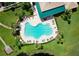 Aerial view of community pool with sun loungers, lush landscaping and walking trail nearby at 5 Captiva At Lionspaw, Daytona Beach, FL 32124