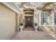 Close up view of a home's front entrance featuring brick walkway, pillars, planters and detailed door at 5 Captiva At Lionspaw, Daytona Beach, FL 32124