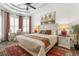 A bright main bedroom featuring a ceiling fan, bay windows, and stylish decor at 5 Captiva At Lionspaw, Daytona Beach, FL 32124