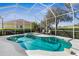 Sparkling screened pool with a spa and ample seating surrounded by lush landscaping and golf course views at 5 Captiva At Lionspaw, Daytona Beach, FL 32124