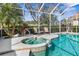 Inviting outdoor pool area with a luxurious hot tub, landscaping, and comfortable seating at 5 Captiva At Lionspaw, Daytona Beach, FL 32124