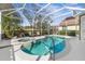 Enclosed pool and spa area with a view of the golf course, featuring comfortable lounge seating and tropical greenery at 5 Captiva At Lionspaw, Daytona Beach, FL 32124