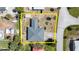 Drone's eye view showcases property lines, roof, nearby landscaping, and surrounding neighborhood streets and dwellings at 11 Briggs Dr, Ormond Beach, FL 32176